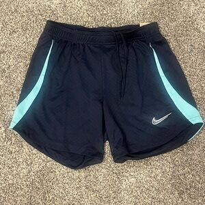 Nike Dark Blue Shorts with Light Blue/Aqua side Stripes (Women’s Small)